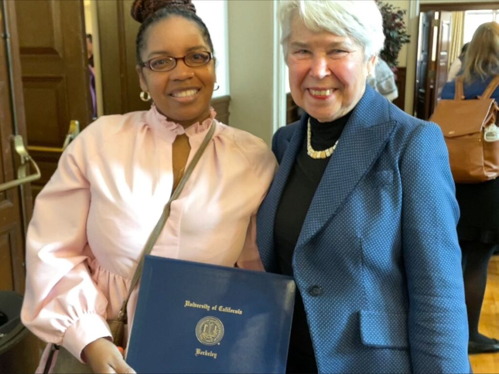 Charron Andrus with award and UC Berkeley's Chancellor 